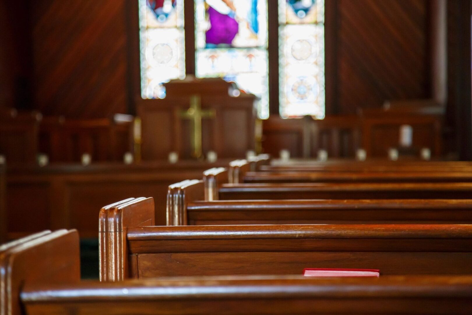 A church with pews and stained glass windows